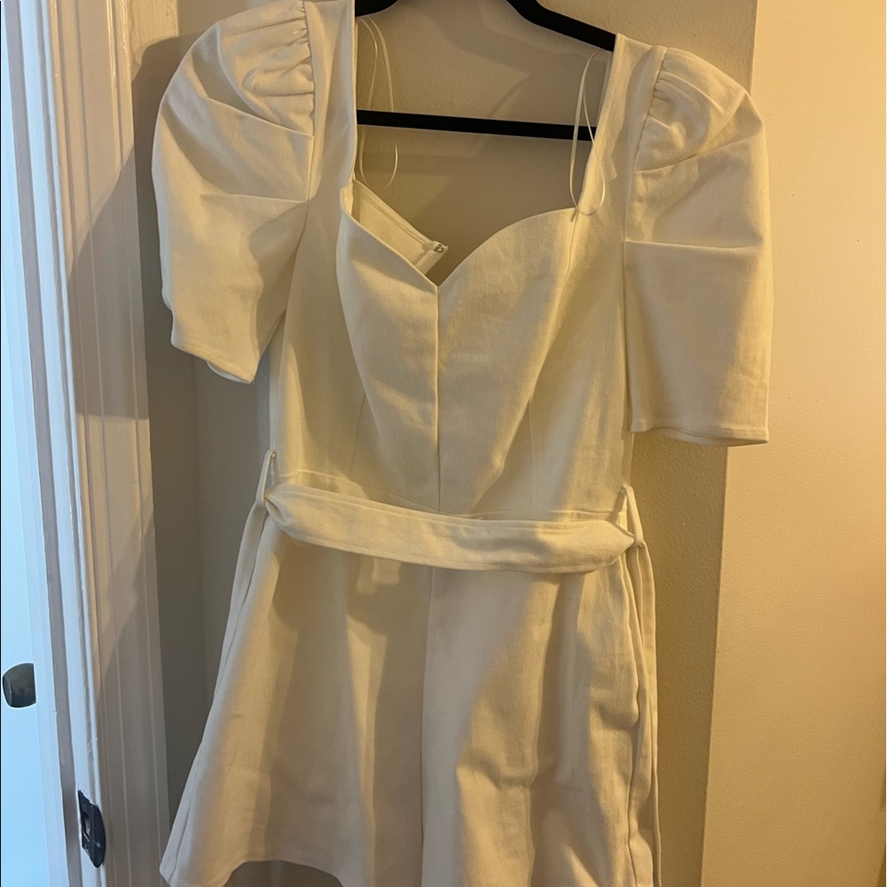 White bridal romper with puff sleeves.